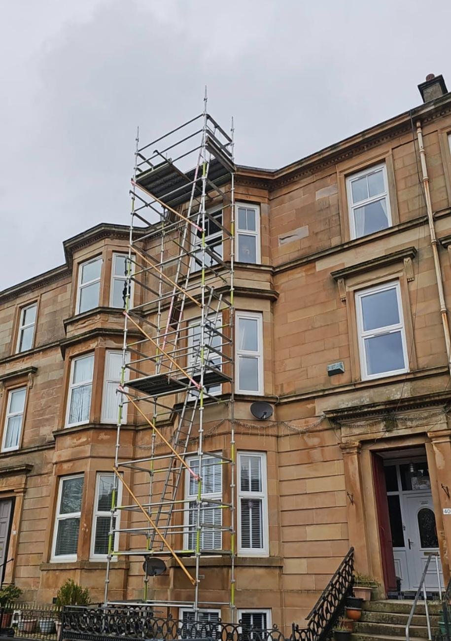 Scaffold tower against a sandstone tenement in Hyndland