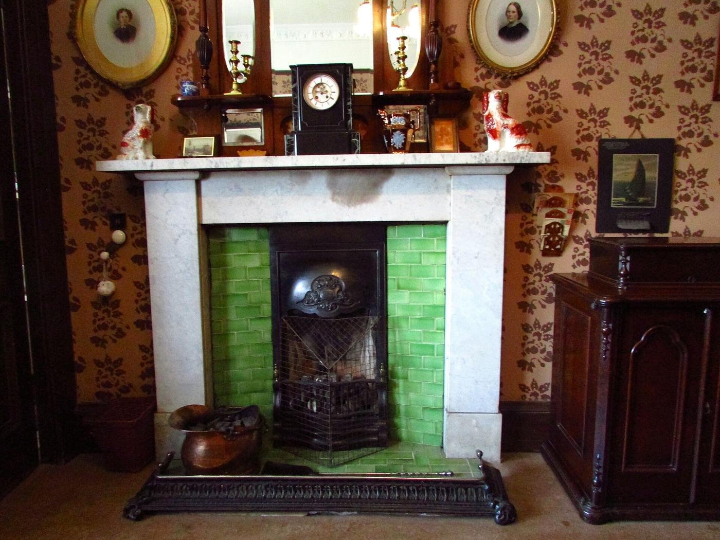 Victorian sitting-room fireplace with green tiles in the Tenement House museum